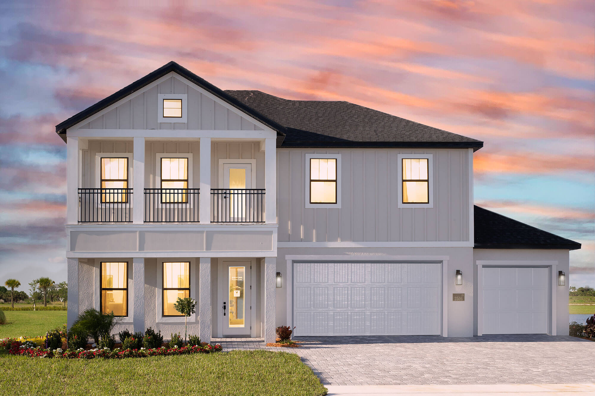 Viera Builders Pangea Park Highland Model exterior 2-story home with pink sunset